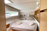 Cozy bedroom in 2018 Nautitech 46 Open catamaran with modern wooden interior.