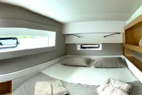 Luxurious cabin interior of 2018 Nautitech 46 Open catamaran with modern design and cozy bedding.