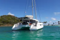 2018 Nautitech 46 Open catamaran anchored in tropical waters with palm trees in background.