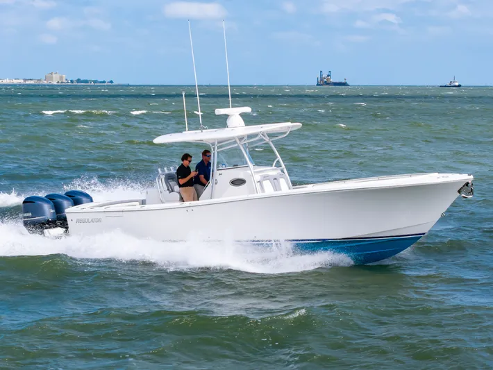 Dauntless Yacht Photos Pics 2018 Regulator 34 FS boat cruising on open water with two people onboard.