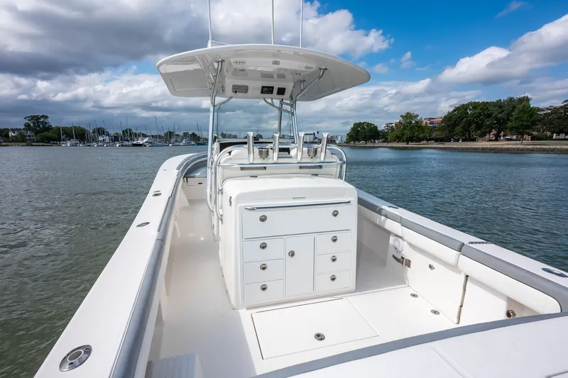 Dauntless Yacht Photos Pics 2018 Regulator 34 FS boat on calm water, featuring a sleek white deck and console.