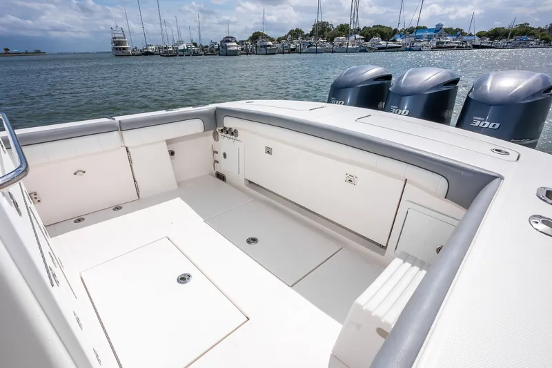 Dauntless Yacht Photos Pics 2018 Regulator 34 FS boat with spacious deck and triple Yamaha 300 engines, docked at marina.