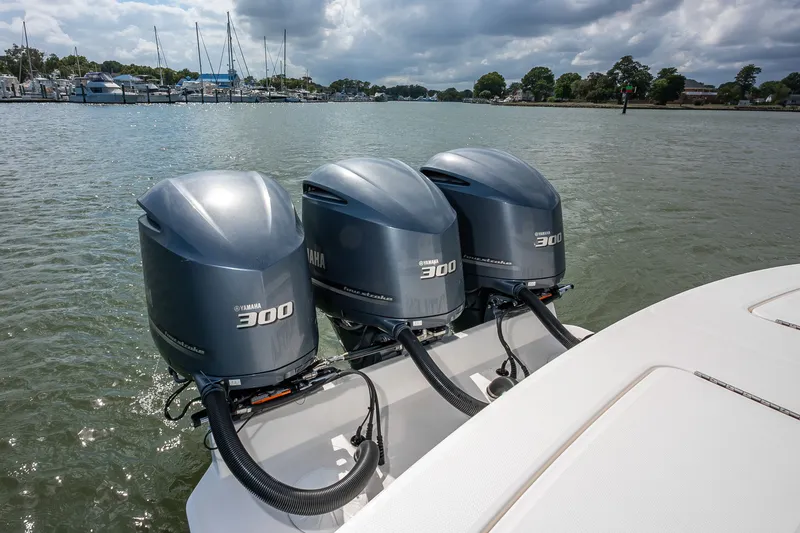 Dauntless Yacht Photos Pics 2018 Regulator 34 FS boat with triple Yamaha 300 engines on a calm waterway.