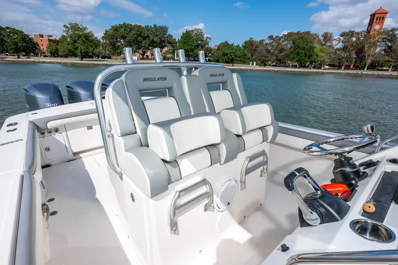 Dauntless Yacht Photos Pics 2018 Regulator 34 FS boat interior with helm seating and dual engines on a scenic waterway.