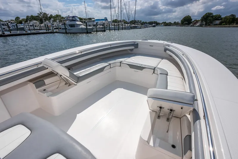 Dauntless Yacht Photos Pics 2018 Regulator 34 FS boat with spacious seating, docked by the marina.