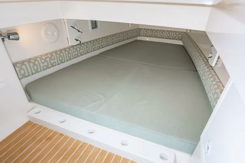Dauntless Yacht Photos Pics 2018 Regulator 34 FS cabin interior with cushioned bed and patterned backrest.