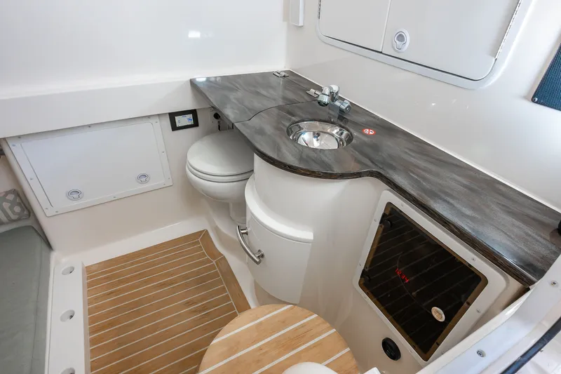 Dauntless Yacht Photos Pics 2018 Regulator 34 FS boat interior with sink, toilet, and wood flooring.