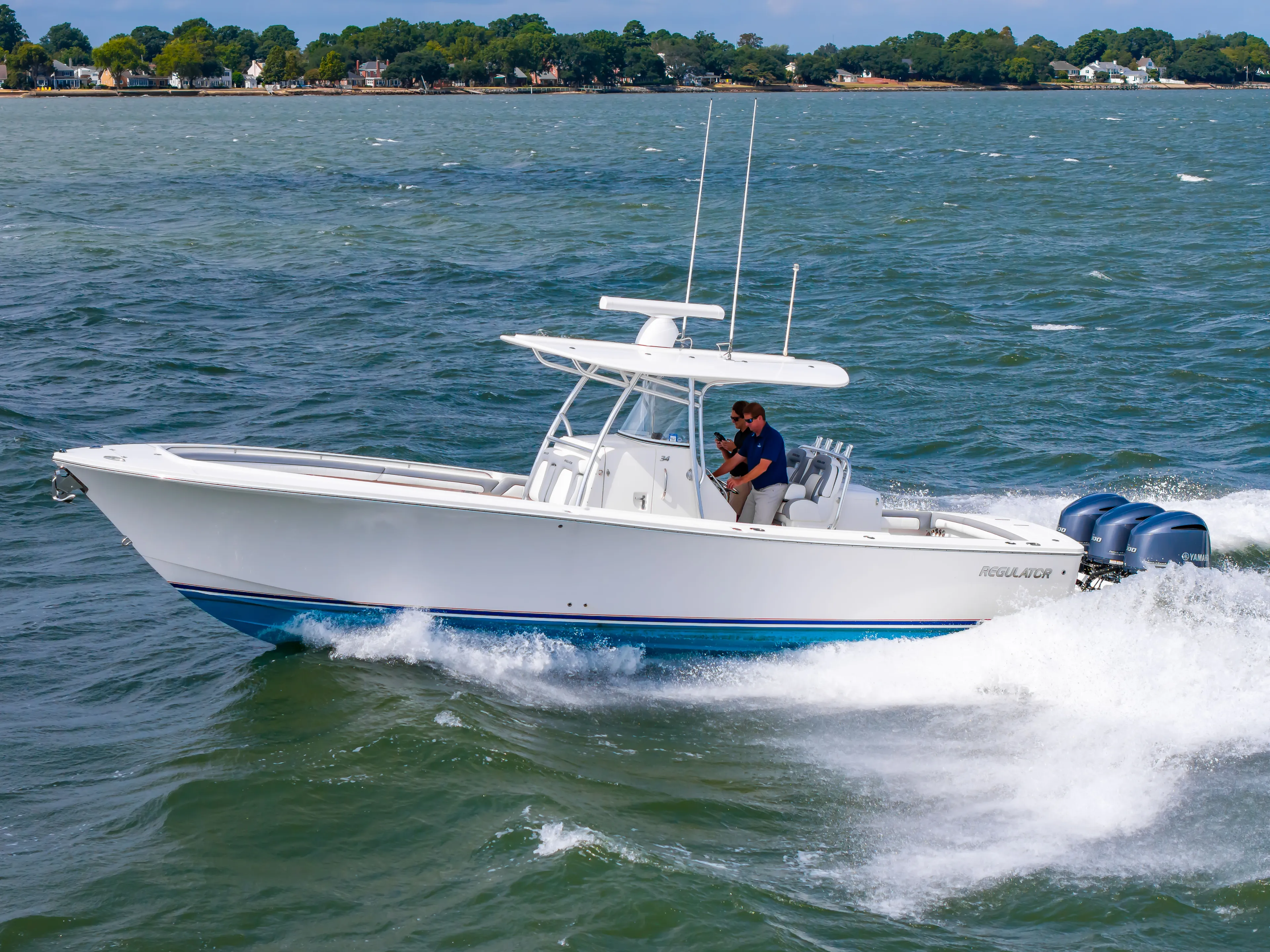 Dauntless Yacht Photos Pics 2018 Regulator 34 FS boat cruising on open water with triple Yamaha engines.