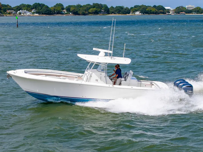 Dauntless Yacht Photos Pics 2018 Regulator 34 FS boat cruising on open water with triple Yamaha engines.