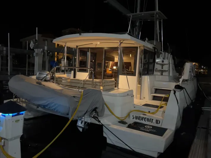 Encore Yacht Photos Pics 2020 Bali 4.1 catamaran docked at night, featuring illuminated interior and exterior.