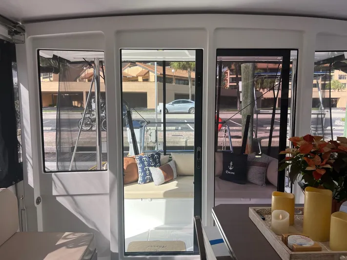 Encore Yacht Photos Pics Interior view of 2020 Bali 4.1 catamaran with cozy seating and decorative candles.