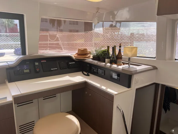 Encore Yacht Photos Pics Interior of 2020 Bali 4.1 yacht with navigation controls, bottles, and decor.