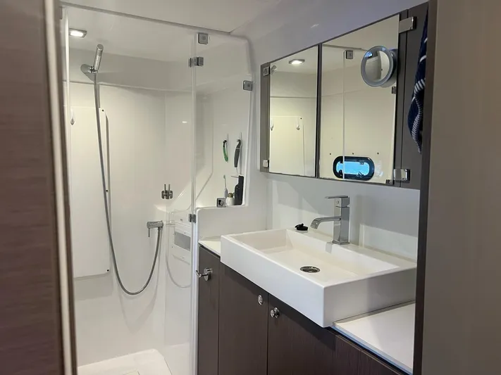Encore Yacht Photos Pics Modern yacht bathroom with shower, sink, and mirrored cabinets in a 2020 Bali 4.1 model.