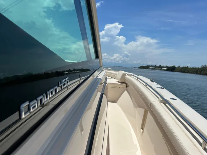 Yacht Photos Pics 2024 Grady-White Canyon 456 boat on water, showcasing sleek design and clear skies.