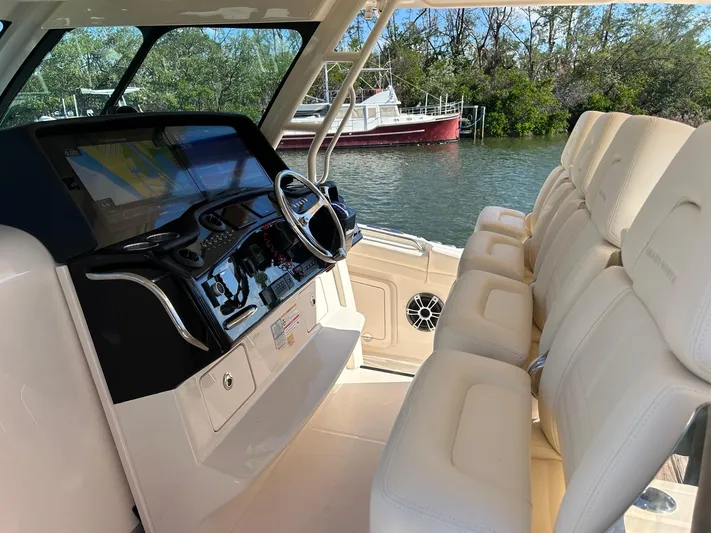  Yacht Photos Pics 2024 Grady-White Canyon 456 boat interior with modern dashboard and plush seating.