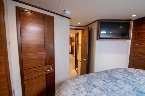 Caballo Grande Yacht Photos Pics 2024 Viking Convertible EB yacht interior with wood paneling and mounted TV.