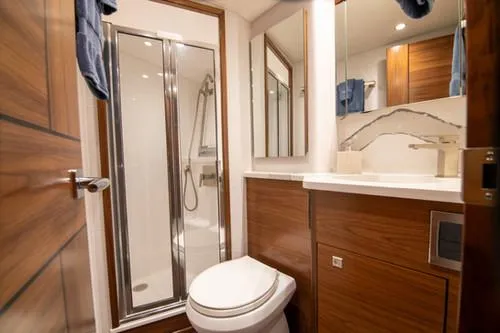 Caballo Grande Yacht Photos Pics Luxurious bathroom in 2024 Viking Convertible EB yacht with modern shower and wood accents.