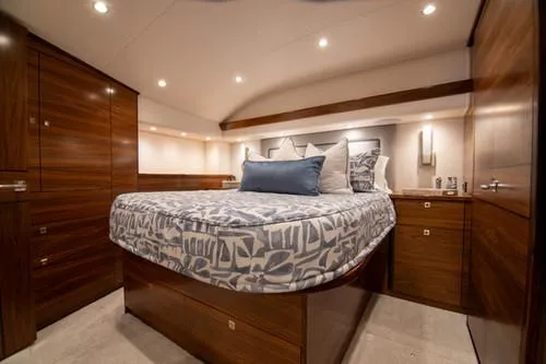 Caballo Grande Yacht Photos Pics Luxurious bedroom interior of 2024 Viking Convertible EB yacht with elegant wood finishes.