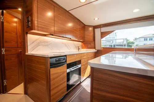 Caballo Grande Yacht Photos Pics Luxurious 2024 Viking Convertible EB yacht kitchen with wood cabinetry and modern appliances.