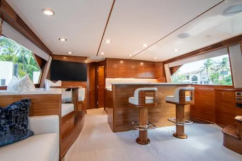 Caballo Grande Yacht Photos Pics Luxurious interior of 2024 Viking Convertible EB yacht with elegant wood finishes and modern seating.