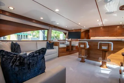 Caballo Grande Yacht Photos Pics Luxurious interior of 2024 Viking Convertible EB yacht with elegant seating and wood finishes.