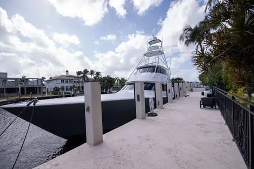 Caballo Grande Yacht Photos Pics 2024 Viking Convertible EB yacht docked at a marina under a partly cloudy sky.