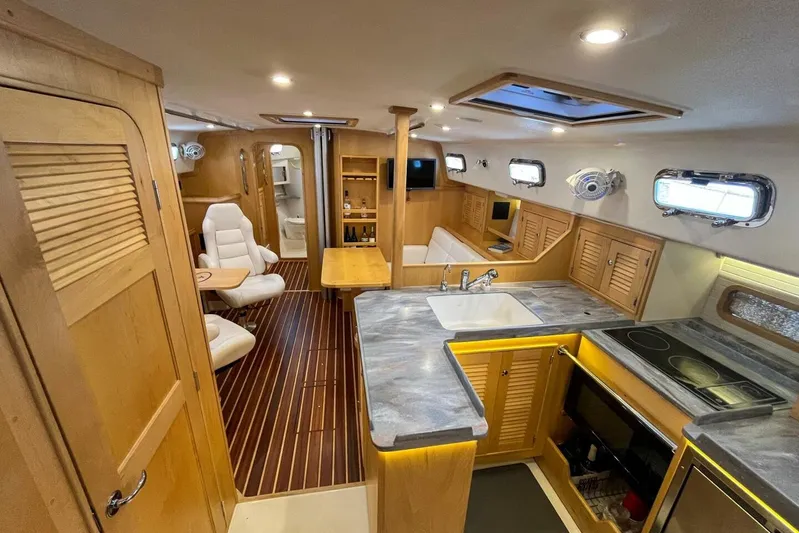  Yacht Photos Pics Luxurious interior of 2023 Island Packet 439 yacht with modern kitchen and seating area.