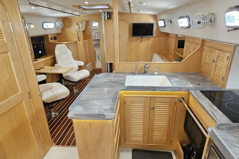  Yacht Photos Pics Luxurious interior of 2023 Island Packet 439 yacht with modern kitchen and seating area.