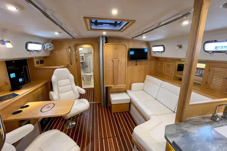  Yacht Photos Pics Luxurious interior of 2023 Island Packet 439 yacht with modern seating and wood finishes.