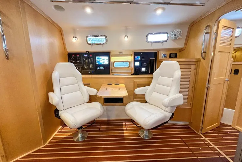  Yacht Photos Pics Luxurious interior of 2023 Island Packet 439 yacht with plush seating and modern navigation controls.