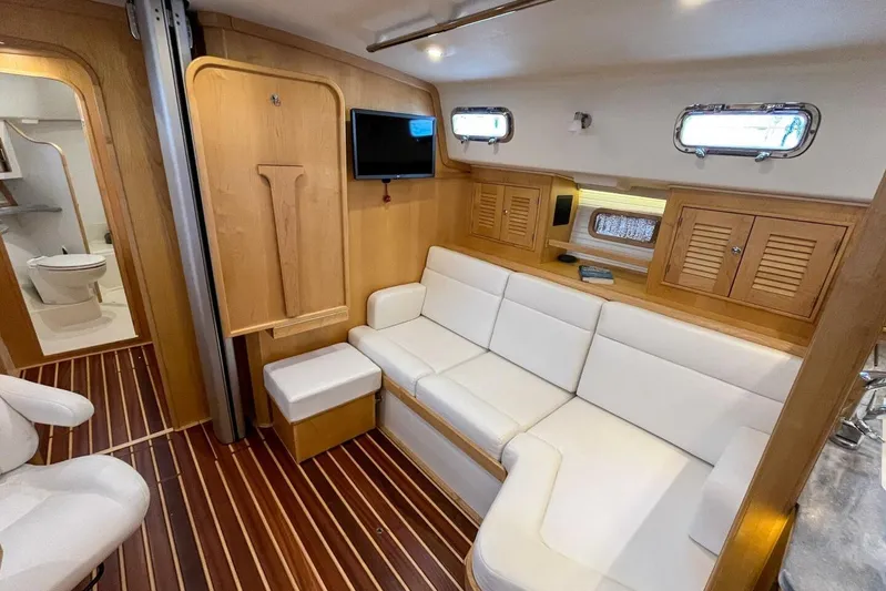  Yacht Photos Pics Luxurious interior of 2023 Island Packet 439 yacht with white seating and wooden accents.