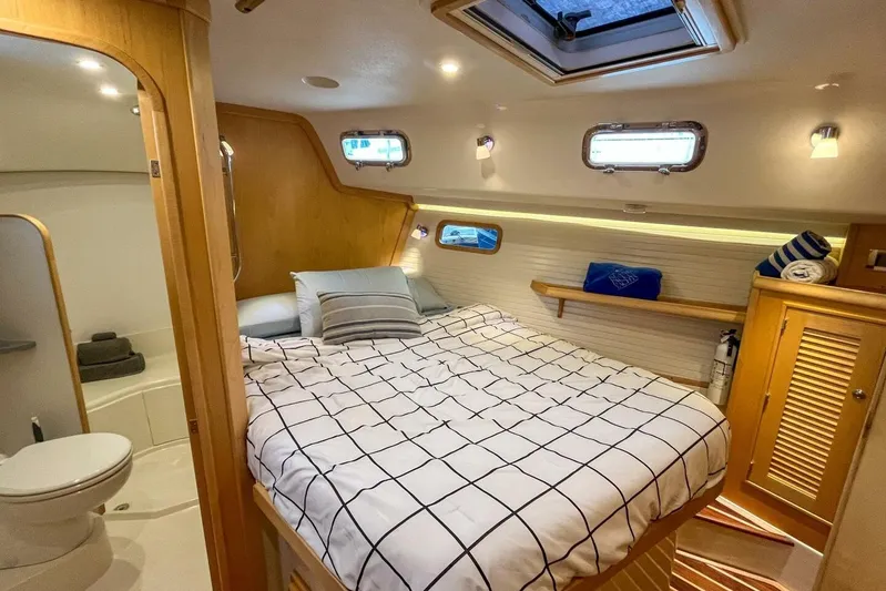  Yacht Photos Pics Luxurious cabin interior of 2023 Island Packet 439 yacht with cozy bed and modern amenities.