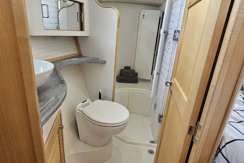  Yacht Photos Pics 2023 Island Packet 439 yacht bathroom with modern fixtures and wooden accents.