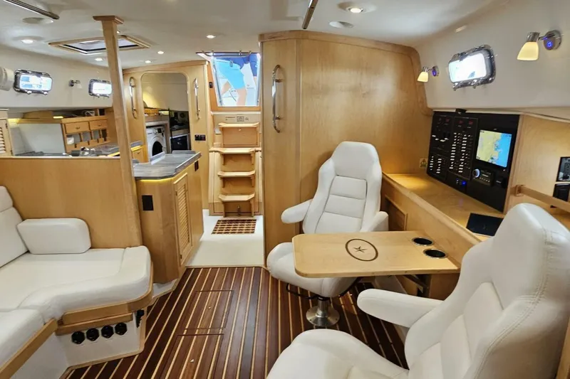  Yacht Photos Pics Luxurious interior of 2023 Island Packet 439 yacht with modern seating and navigation area.