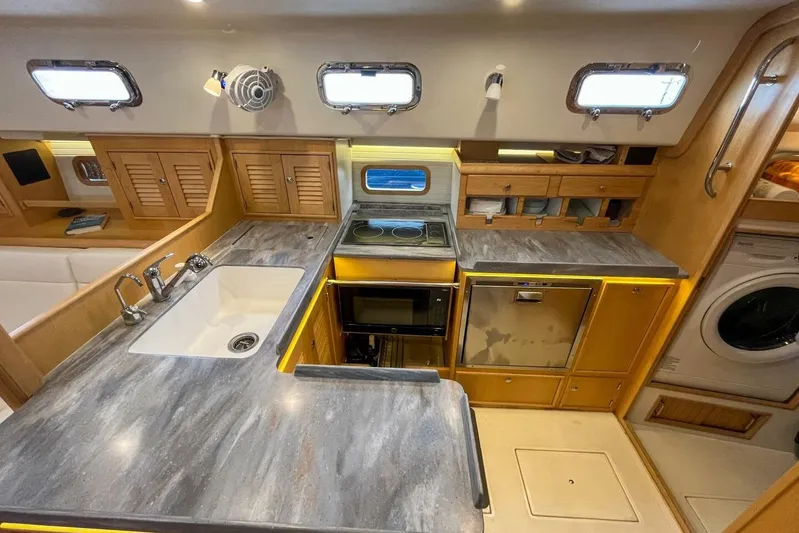  Yacht Photos Pics Modern galley kitchen in 2023 Island Packet 439 yacht with sleek countertops and appliances.