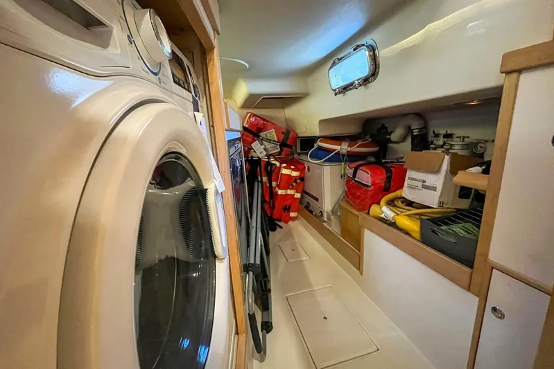  Yacht Photos Pics Laundry area and storage in 2023 Island Packet 439 yacht, featuring washer and organized equipment.