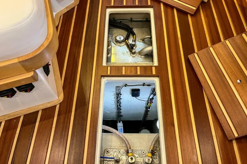  Yacht Photos Pics 2023 Island Packet 439 yacht interior with open floor compartments, showcasing wooden finish.