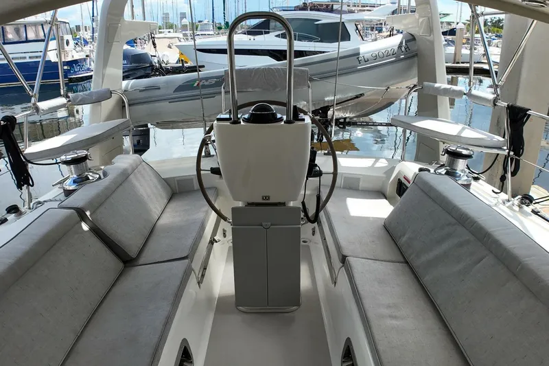  Yacht Photos Pics 2023 Island Packet 439 yacht cockpit with steering wheel and seating at marina.