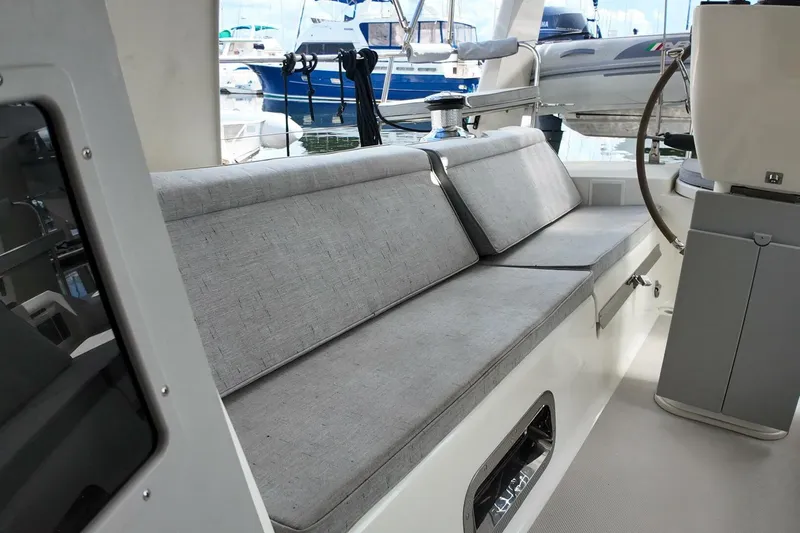  Yacht Photos Pics 2023 Island Packet 439 yacht interior with cushioned seating and helm station.