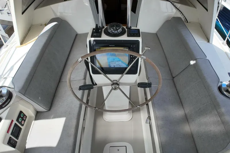  Yacht Photos Pics 2023 Island Packet 439 yacht cockpit with steering wheel and navigation system.