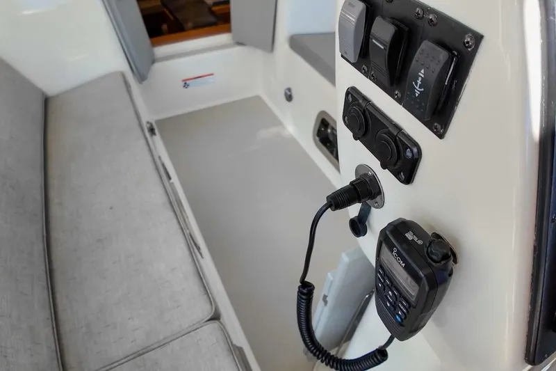  Yacht Photos Pics Interior view of 2023 Island Packet 439 sailboat with control panel and seating area.