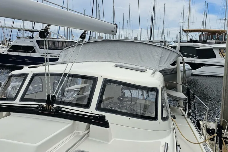  Yacht Photos Pics 2023 Island Packet 439 sailboat docked in a marina, surrounded by other boats.