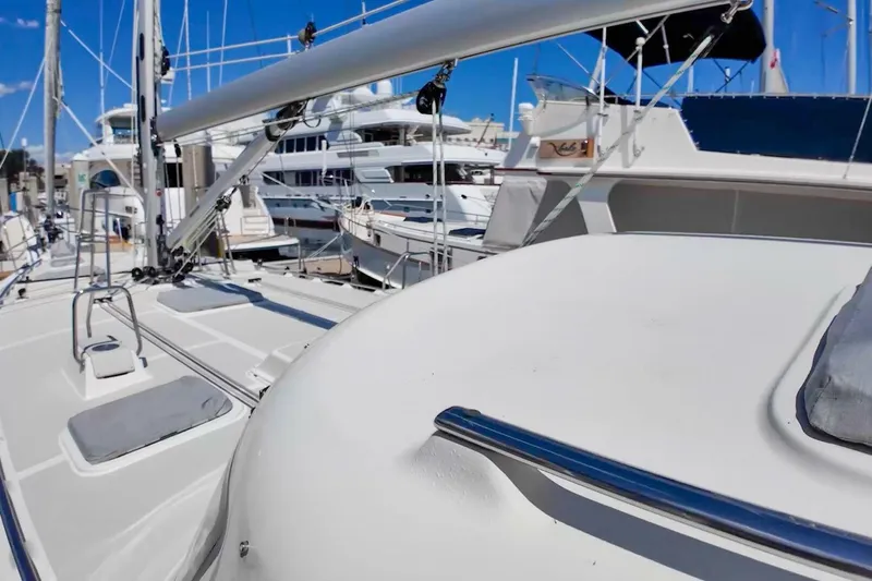  Yacht Photos Pics 2023 Island Packet 439 sailboat deck with marina background, showcasing sleek design and modern features.