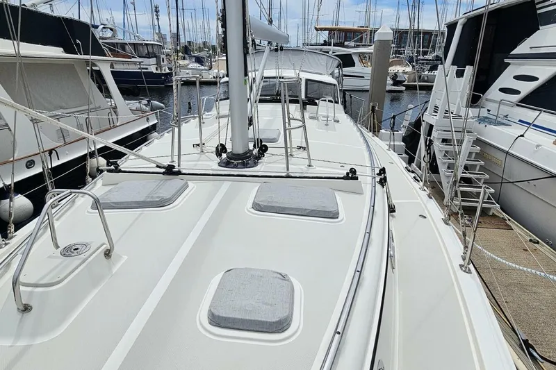  Yacht Photos Pics 2023 Island Packet 439 sailboat deck view in marina, surrounded by other boats.