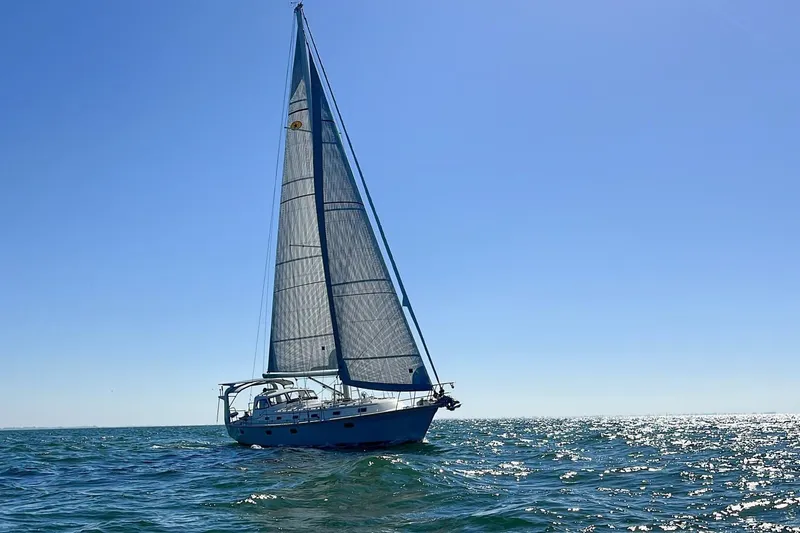  Yacht Photos Pics Sailing yacht Island Packet 439, 2023 model, gliding on open sea under clear blue sky.