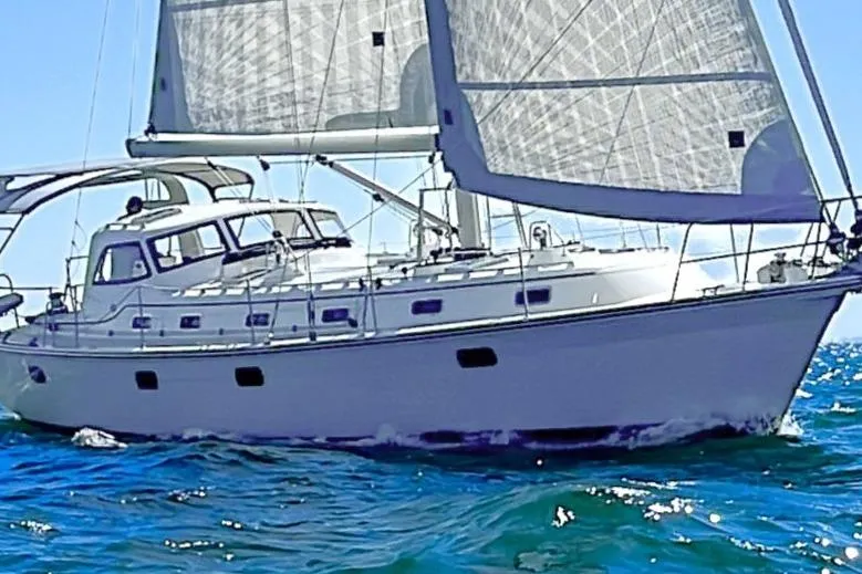  Yacht Photos Pics 2023 Island Packet 439 sailboat navigating ocean waters under full sail.