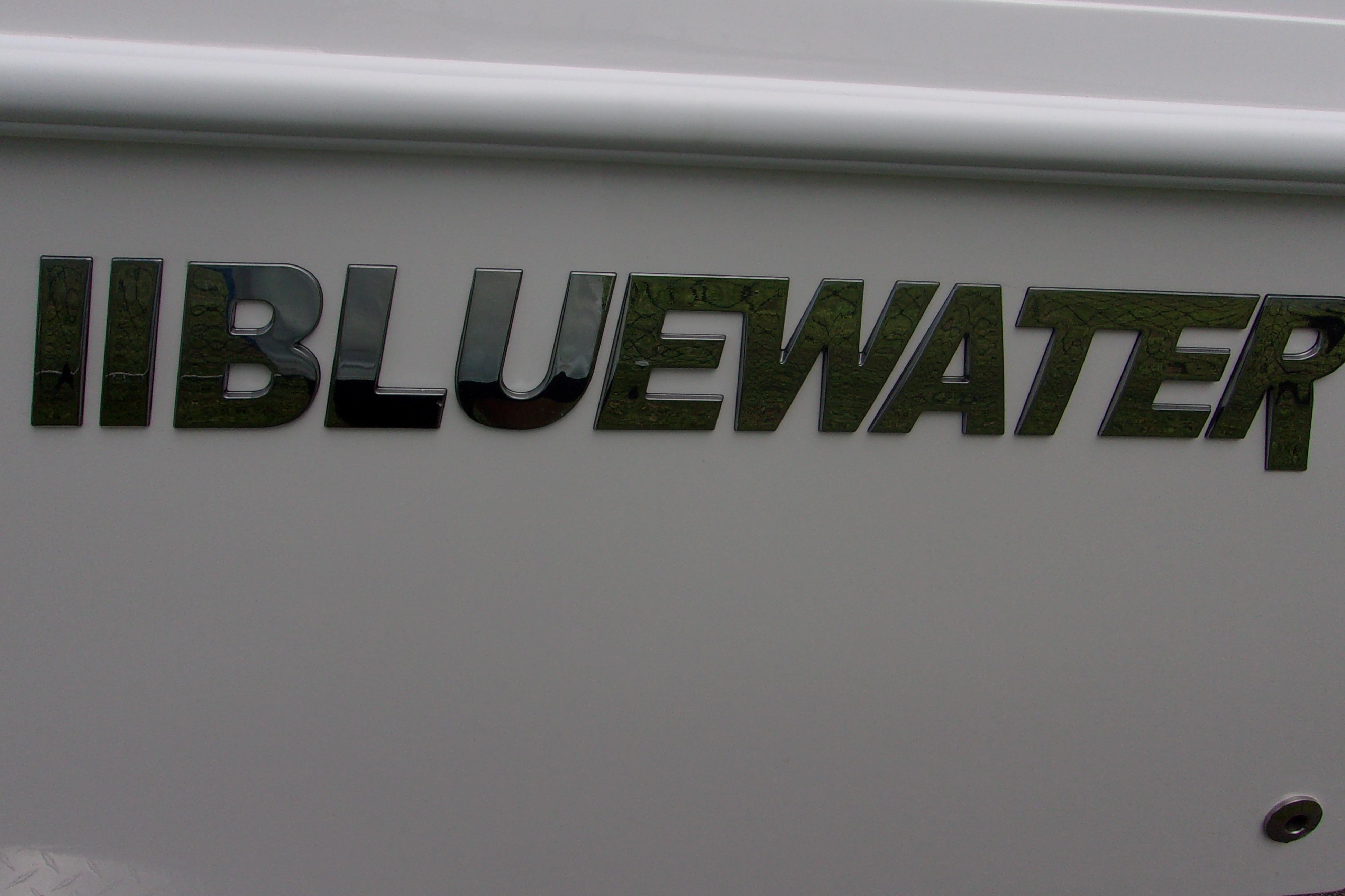 2025 Bluewater 23 T boat logo on white surface.