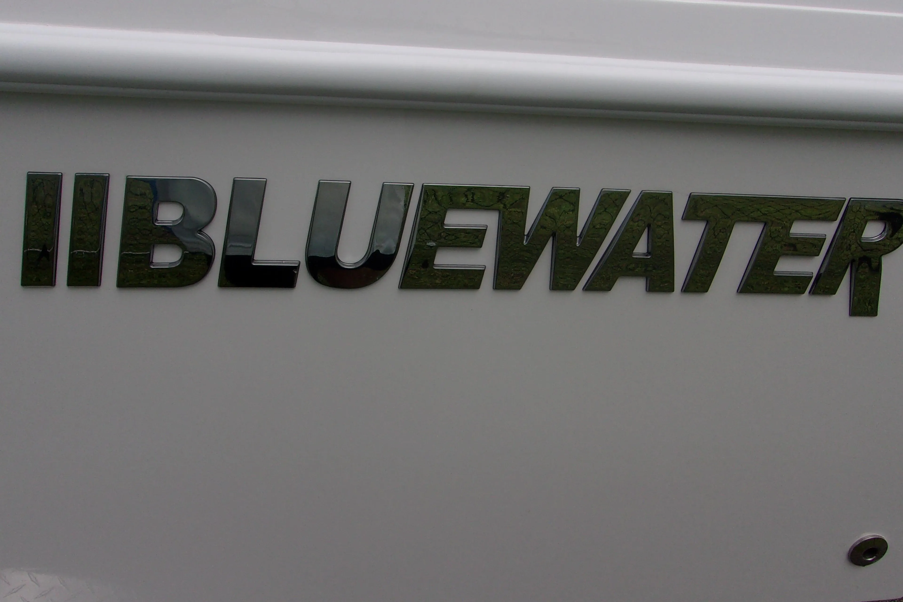 2025 Bluewater 23 T boat logo on white surface.