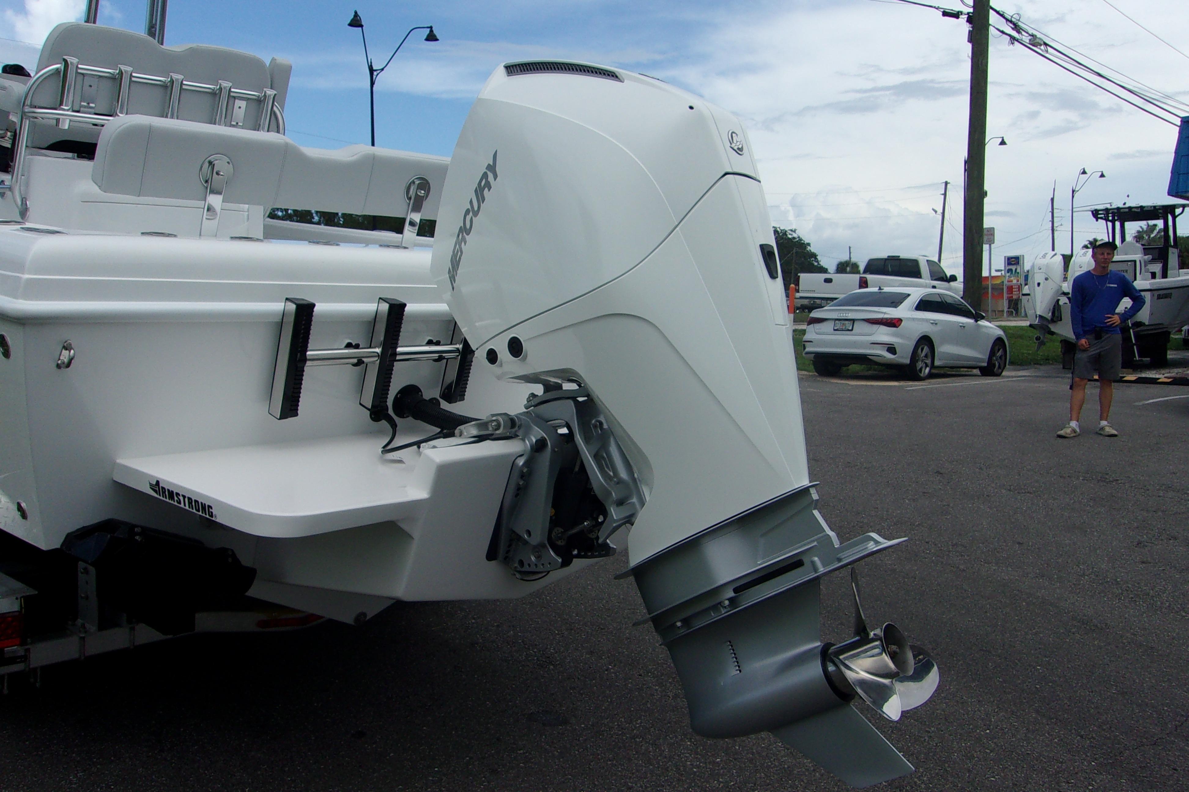 2025 Bluewater 23 T boat with Mercury outboard motor in a parking lot.