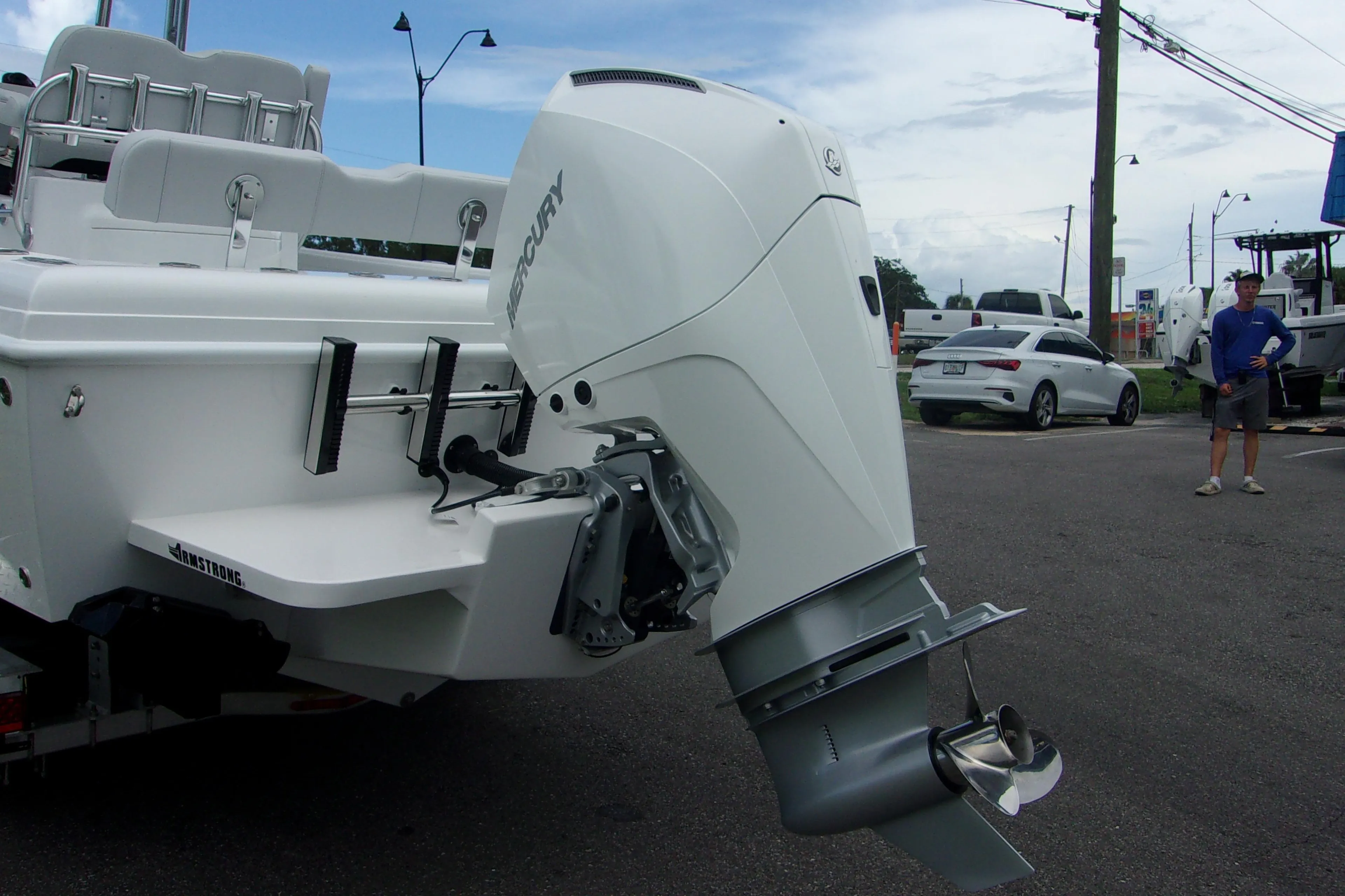 2025 Bluewater 23 T boat with Mercury outboard motor in a parking lot.